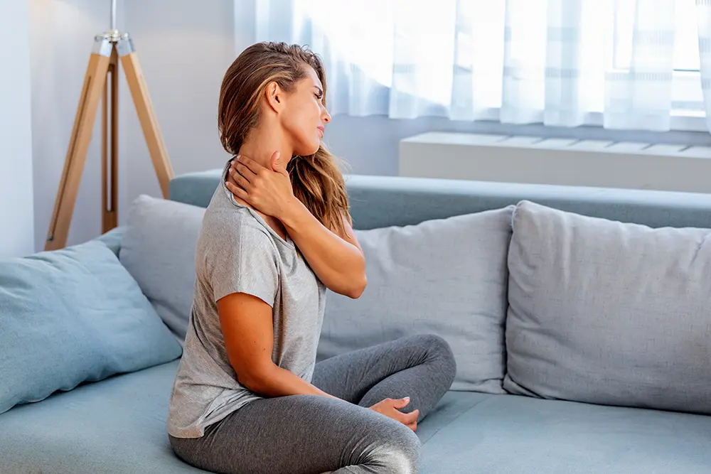 woman grabbing neck in pain