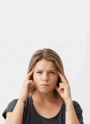 Woman experiencing face and jaw pain